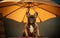 Close up of a french bulldog in shade of a sun umbrella. Summertime composition