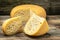 close up french hard cheese with holes emmentaler on a wooden background. farmer market. top view. place for text