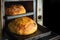 Close-up of fresh artisanal bread baked in vintage oven in cooking and eating concept. Homemade baking
