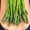 Close up of fresh asparagus on wooden board.