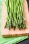 Close up of fresh asparagus on wooden board.