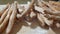 Close-up of fresh baked baguettes lying in pile on the wooden table