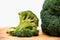 Close up on Fresh broccoli solated on wooden and white background