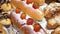 Close up of fresh buns with strawberry and cream on pastry shop counter