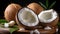 Close-up of fresh coconuts halved on a wooden surface, revealing creamy white flesh, accompanied by vibrant green leaves and