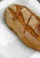 Close-up of fresh crispy tasty oval rye bread on a light background.