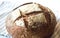 Close-up of fresh and crusty sourdough artisan bread on towel