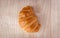 Close up of fresh delicious croissants on wooden background