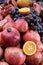 Close up of fresh fruits grapes, pomegranates and oranges