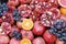 Close up of fresh fruits grapes, pomegranates and oranges