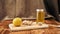 Close up of fresh ginger, lemon, honey in a jar with dropper on the wooden board, Preparation of cold and flu remedy