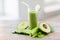 Close up of fresh green juice glass and vegetables