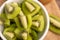 Close-up fresh green kiwis slice in the white bowl