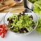 Close up of fresh healthy full of vitamins salad in glass plate