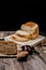 Close up fresh homemade loafs bread and sliced bread on cutting board with jam strawberry on wooden background.Healthy Diet.Prepar