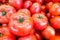 Close up of fresh, juicy, ripe tomatoes pile. lycopene and antioxidant in fruit nutrition good for health and skin. flat lay.
