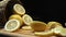 Close up of fresh lemon slices are arranged against a rustic basket. Comestible.