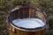 Close up of fresh milk in a wooden bucket.