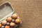 Close up of fresh organic chicken eggs from local farmer market in paper box on tablecloth, selective focus. World egg day concept