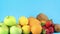 Close up of fresh organic fruits pile on blue background