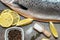 Close up Fresh raw salmon, red fish with spices, salt, lemon, pepper, rosemary on dark wooden background. salmon cooking. Sea fish