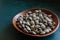 Close up of Fresh raw Surf chamelea gallina in the wooden bowl on blue concrete background