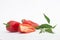 Close-up of fresh red peppers, two whole and one paprika  slice on white background