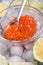 Close up fresh red  salmon caviar with spoon and  lime around ice. macro shot.  Protein luxury delicacy  healthy food