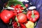 Close up of fresh red vegetable bell pepper, tomato, chilis in waste bin