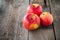 Close up fresh Ripe organic red apples with water drops on the rustic wooden table. Space for text. Selective focus. Autumn harves