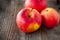 Close up fresh Ripe organic red apples with water drops on the rustic wooden table. Space for text. Selective focus. Autumn harves