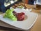 Close up fresh Steak tartare with lettuce leaves on white plate,