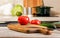 Close-up fresh vegetables on a cutting board. Kitchen accessories. Chopping wooden boards and utensils. Ripe tomatoes and