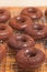 Close up of freshly baked chocolate donuts, cooling