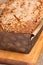 Close up of freshly baked, homemade, cranberry, pecan bread loaf in cardboard form