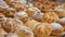 Close-up freshly baked pastry goods on display in bakery shop. Selective focus