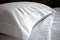 close-up of freshly laundered pillowcase, with intricate stitching and luxurious satin finish