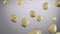 Close-up of freshly peeled hazelnuts bouncing and spinning on white background