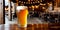 Close-up of a freshly poured glass of light beer with foam on a bar counter or wooden table against a background of a