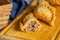 Close up of fried Argentine empanada cut in the middle on a wooden board