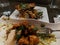 Close-up of fried cauliflower dish and sweet potatoes, garnished with cilantro