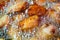 Close up fried chicken wings in boiling oil.