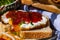 Close up of fried egg with tomato sauce and garlic on toast bread isolated