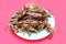 Close up fried grasshopper or belalang goreng is traditional food from southeast asia