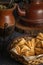 Close up fried pastries stuffed with sweet potato or quince with yerba mate and a kettle. Typical Argentine food