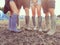 Close Up Of Friends In Wellington Boots Walking To Festival