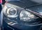 Close-up front headlight with xenon light of black modern car