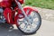 Close-up front part of retro custom motorcycle. Shining chrome vintage bike wheel with red fender