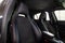 Close-up on the front sport car seats with black leather trim, lateral support and fabric inserts, of used vehicle in after