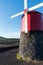 Close up front view of a restored traditional red windmill on Pico Island in the Azores